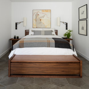 Design ideas for a midcentury master bedroom in Seattle with white walls, porcelain floors and grey floor.