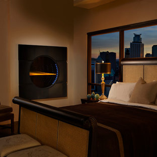 Imagen de dormitorio principal, moderno, de tamaño medio, con paredes marrones, suelo de madera oscura, chimenea tradicional, marco de chimenea de metal y suelo marrón