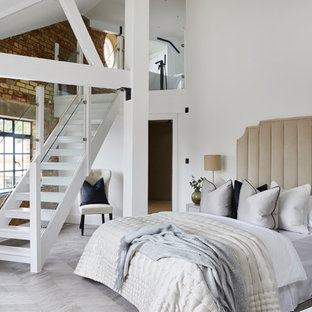 Classic bedroom in London with white walls and grey floors.