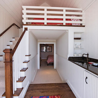 Foto de dormitorio tipo loft, exótico, grande, sin chimenea, con paredes blancas y suelo de madera oscura