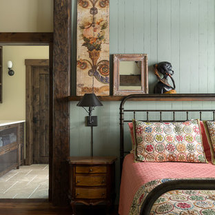 Modelo de habitación de invitados rural, de tamaño medio, con paredes verdes, suelo de madera en tonos medios y suelo marrón