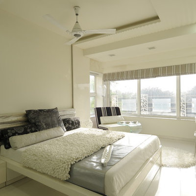 Inspiration for an eclectic bedroom remodel in Mumbai with white walls