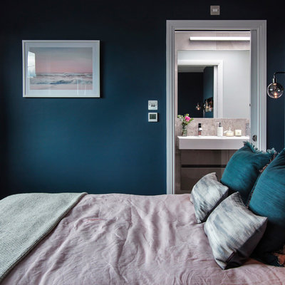 Bedroom - mid-sized contemporary master dark wood floor and brown floor bedroom idea in London with blue walls
