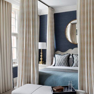 This is an example of a large classic master bedroom in London with blue walls, carpet and grey floors.
