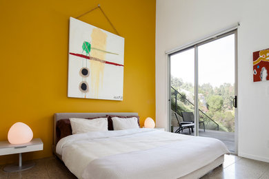 Modelo de habitación de invitados moderna de tamaño medio sin chimenea con paredes amarillas y suelo de baldosas de cerámica