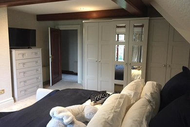 Photo of a medium sized contemporary master bedroom in Other with grey walls, carpet, no fireplace and beige floors.