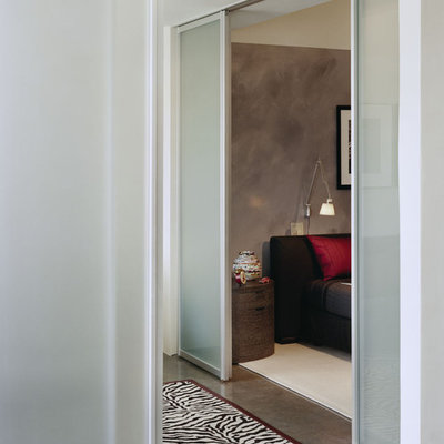 Inspiration for a modern concrete floor bedroom remodel in Boston with gray walls