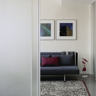 Example of a minimalist concrete floor bedroom design in Boston with white walls