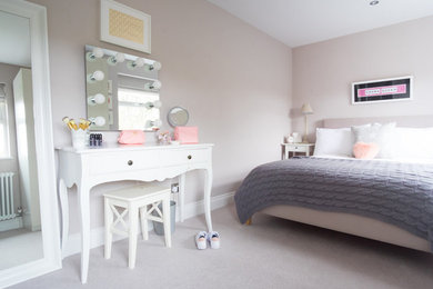 Medium sized contemporary guest bedroom in West Midlands with beige walls, carpet and grey floors.