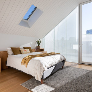 Small contemporary master bedroom in Melbourne with white walls, light hardwood floors and brown floor.