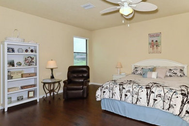 Bedroom - large coastal master dark wood floor and brown floor bedroom idea in Tampa with beige walls and no fireplace