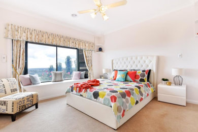This is an example of a medium sized contemporary bedroom in Adelaide with white walls, carpet and beige floors.