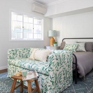 Photo of a mid-sized transitional bedroom in Brisbane with grey walls, medium hardwood floors and brown floor.
