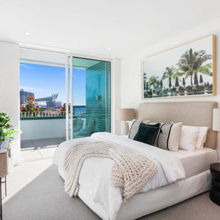 Photo of a contemporary bedroom in Central Coast with white walls, carpet, no fireplace and grey floor.