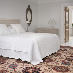 This is an example of a vintage master bedroom in Other with grey walls, painted wood flooring and white floors.