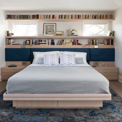 Inspiration for a contemporary light wood floor bedroom remodel in Toronto with white walls