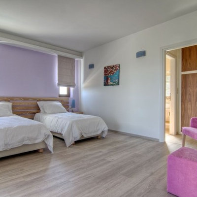 Bedroom - contemporary guest light wood floor bedroom idea in Other with purple walls