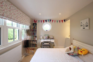 Photo of a farmhouse master bedroom in London with carpet.