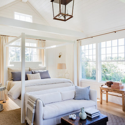 Inspiration for a large coastal master medium tone wood floor and brown floor bedroom remodel in Boston with white walls and no fireplace