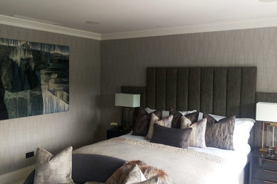 Inspiration for a modern master bedroom in London with beige walls, carpet and beige floors.