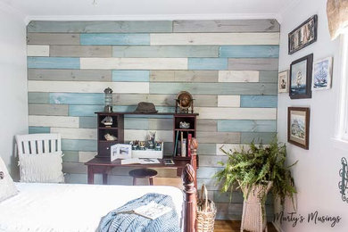 Photo of a small beach style bedroom in Other with white walls and medium hardwood flooring.