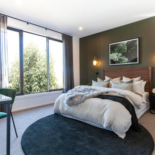 Design ideas for a large contemporary bedroom in Melbourne with green walls, carpet, beige floor and panelled walls.