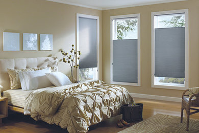 Example of a mid-sized transitional master bamboo floor bedroom design in Other with beige walls and no fireplace