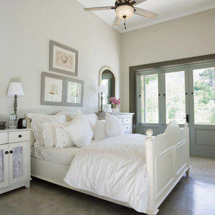 Inspiration for a shabby-chic style bedroom in Other with beige walls, concrete floors and grey floor.