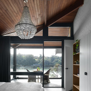 Large contemporary master bedroom in Sydney with white walls, ceramic floors, no fireplace and grey floor.