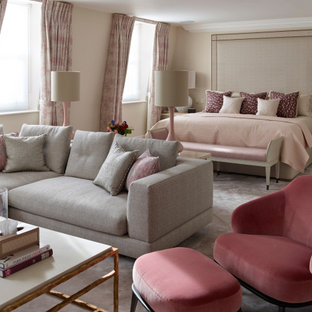 Inspiration for an expansive classic master bedroom in London with beige walls, carpet and beige floors.