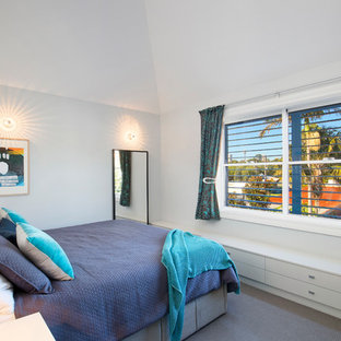 Contemporary guest bedroom in Sydney with white walls, carpet, no fireplace and grey floor.