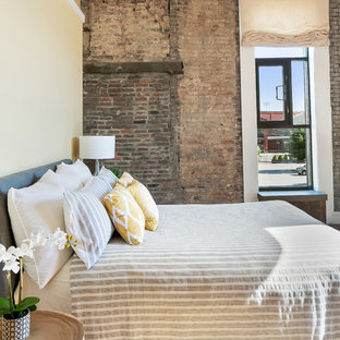 Foto de dormitorio tipo loft, urbano, sin chimenea, con paredes amarillas y suelo de madera en tonos medios