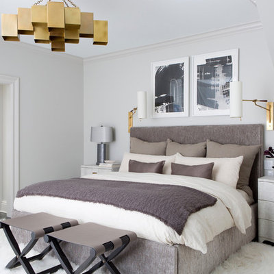 Transitional dark wood floor and brown floor bedroom photo in New York with white walls