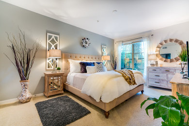This is an example of a large contemporary master bedroom in Orange County with grey walls, carpet and beige floors.