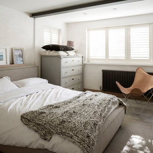Inspiration for a medium sized beach style guest bedroom in Sussex with beige walls, no fireplace and light hardwood flooring.