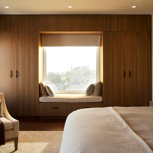 Ispirazione per una grande camera matrimoniale design con pareti beige e parquet scuro