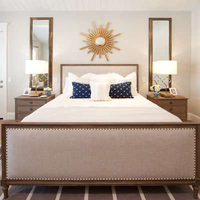 Transitional medium tone wood floor bedroom photo in Phoenix with beige walls