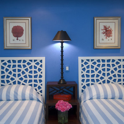 Example of an island style bedroom design in Other with blue walls