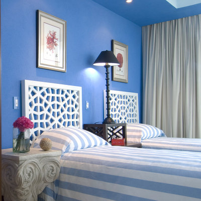 Inspiration for a tropical bedroom remodel in Other with blue walls