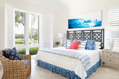 Example of a beach style master beige floor bedroom design in Other with white walls and no fireplace