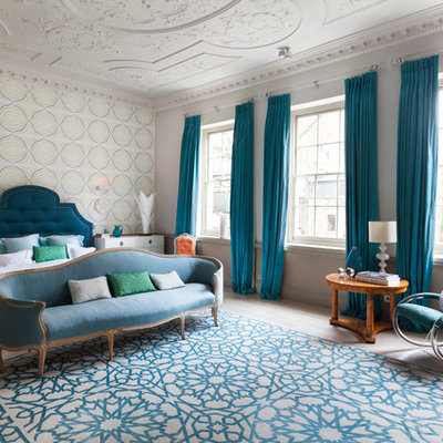 Large trendy master light wood floor bedroom photo in London with multicolored walls