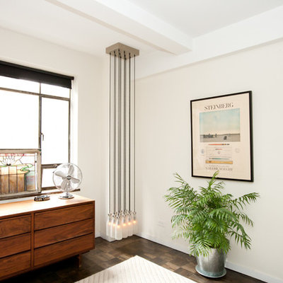 Example of an eclectic bedroom design in New York with white walls