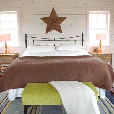 Bedroom - eclectic medium tone wood floor bedroom idea in Toronto with white walls