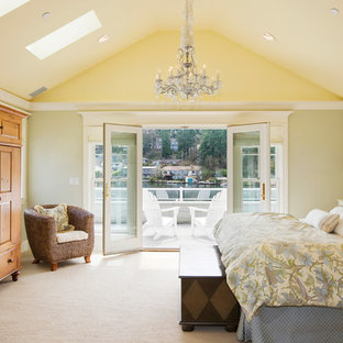 This is an example of a traditional master bedroom in Miami with yellow walls and carpet.