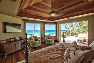 Large island style master medium tone wood floor and brown floor bedroom photo in Hawaii with beige walls and no fireplace