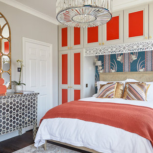 Design ideas for a medium sized eclectic master and grey and brown bedroom in London with grey walls, dark hardwood flooring and brown floors.
