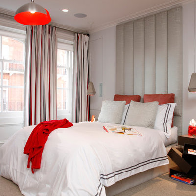 Example of a mid-sized trendy carpeted bedroom design in London with white walls