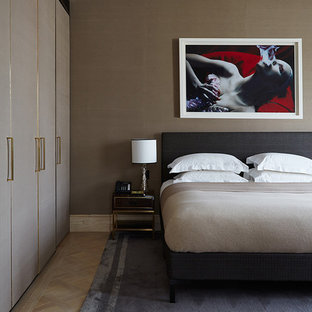 Design ideas for a large contemporary master bedroom in London with brown walls, light hardwood flooring and beige floors.