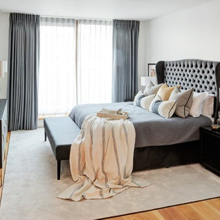 Photo of a medium sized classic master bedroom in London with white walls, light hardwood flooring, no fireplace and brown floors.