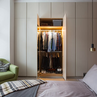 Contemporary bedroom in London with brown walls, carpet and beige floors.